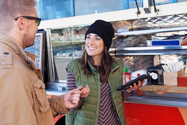 Entrepreneur and customer at concession stand --- Image by © Aurora/Corbis